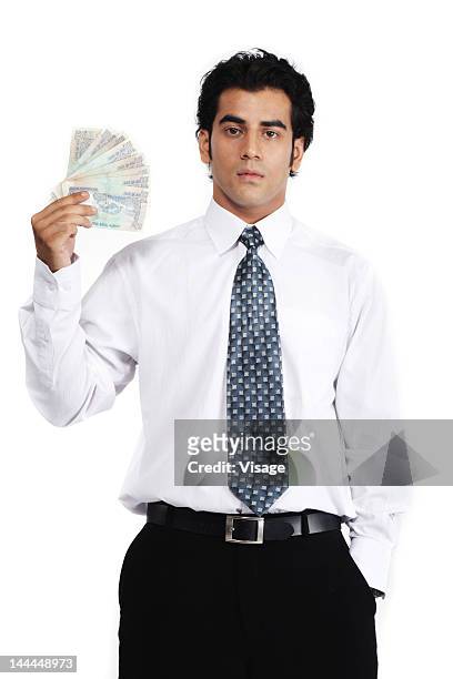 a businessman holding currency notes - rupee stock pictures, royalty-free photos & images