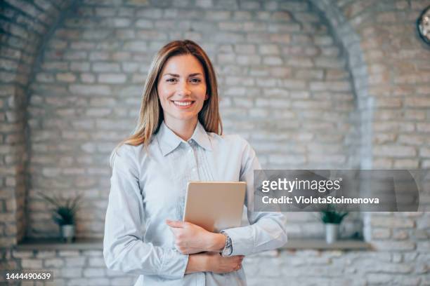 confident businesswoman in modern office. - hr manager stock pictures, royalty-free photos & images