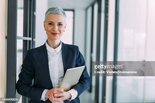 confident businesswoman in modern office. - ceo stock pictures, royalty-free photos & images