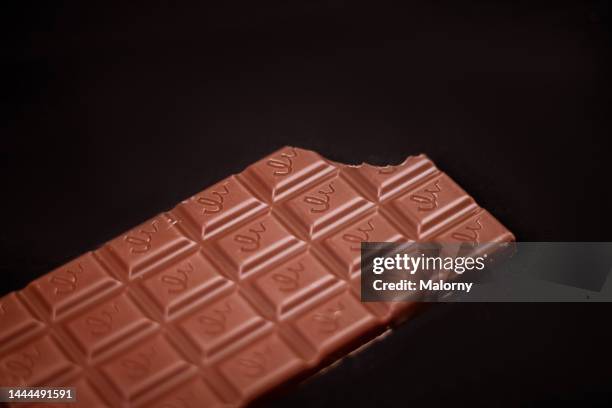 bar of chocolate on black background. - caramel block stock pictures, royalty-free photos & images