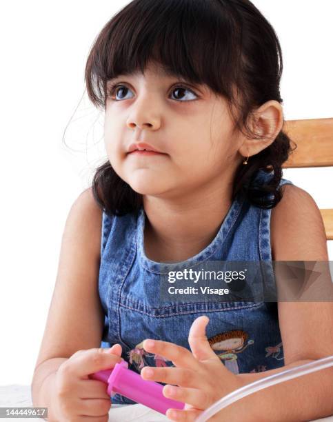 portrait of a girl holding a toy injection - visage close up stock pictures, royalty-free photos & images