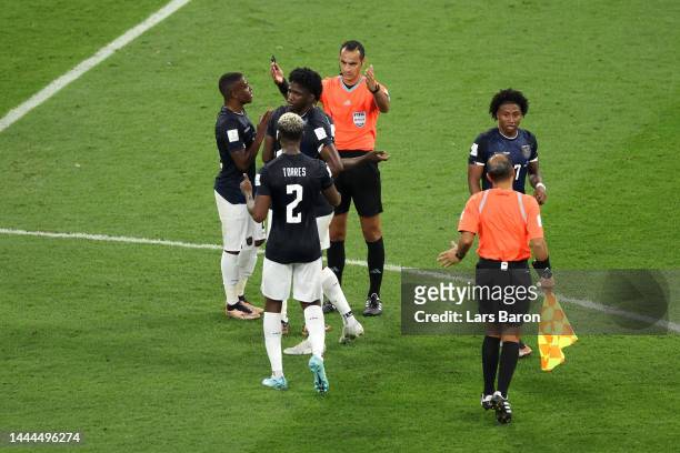 Ecuador players argue with referee Mustapha Ghorbal and match officials after a goal by Pervis Estupinan was ruled offside during the FIFA World Cup...