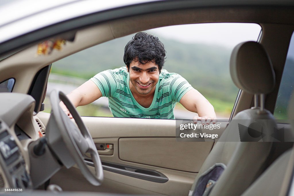 A person peeping through a car window
