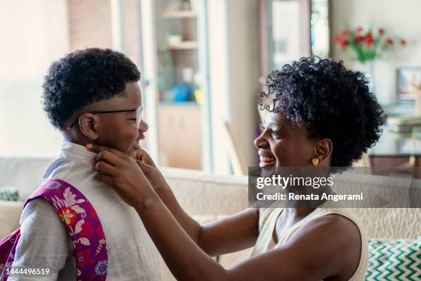 mother preparing son to go to school - academic freedom stock pictures, royalty-free photos & images