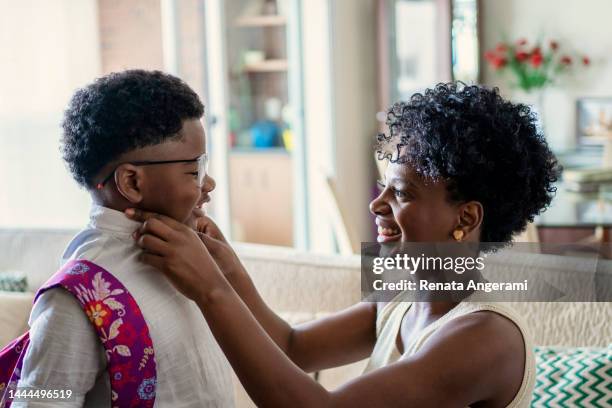 mother preparing son to go to school - homemaker stock pictures, royalty-free photos & images