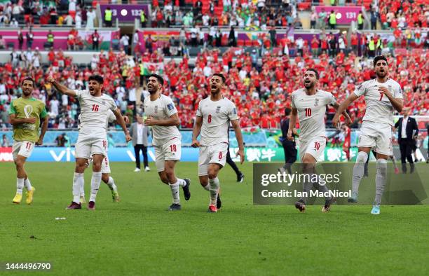 Ali Karimi, Morteza Pouraliganji, KarimAnsarifard and Alireza Jahanbakhsh of Iran celebrate at full time after defeating Wales 0-2 during the FIFA...