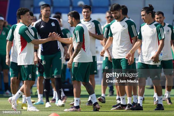 Jorge Sanchez of Mexico greets teammate Alexis Vega during the Mexico Training Session at Al Khor SC on November 25, 2022 in Doha, Qatar.