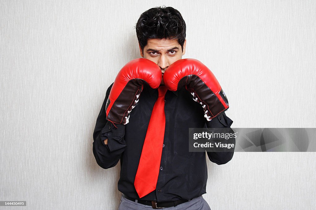 Portrait of a man wearing boxing gloves