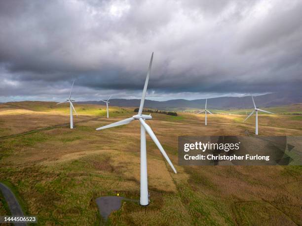 In this aerial view, wind turbines adorn the landscape in the southern Lake District on November 25, 2022 in Lambrigg, England. Two former...