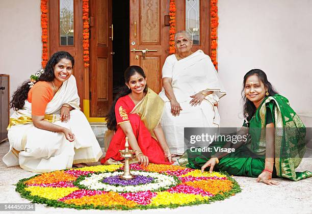 women arranging a floral decoration - onam foto e immagini stock