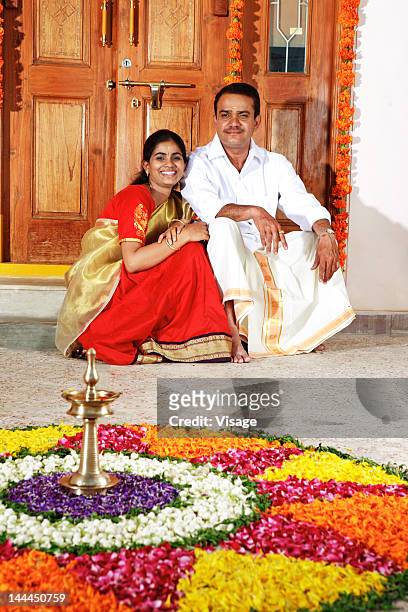people near a floral decoration - onam stock pictures, royalty-free photos & images