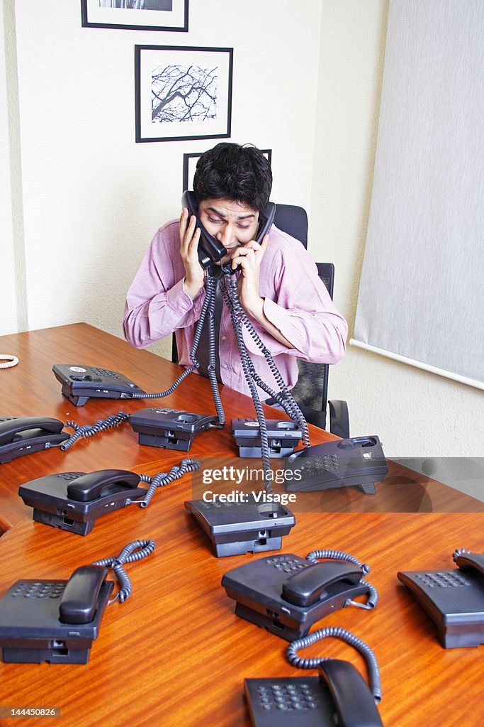 Man Using Many Phones Man Talking On Many Phones High-Res Stock Photo - Getty Images