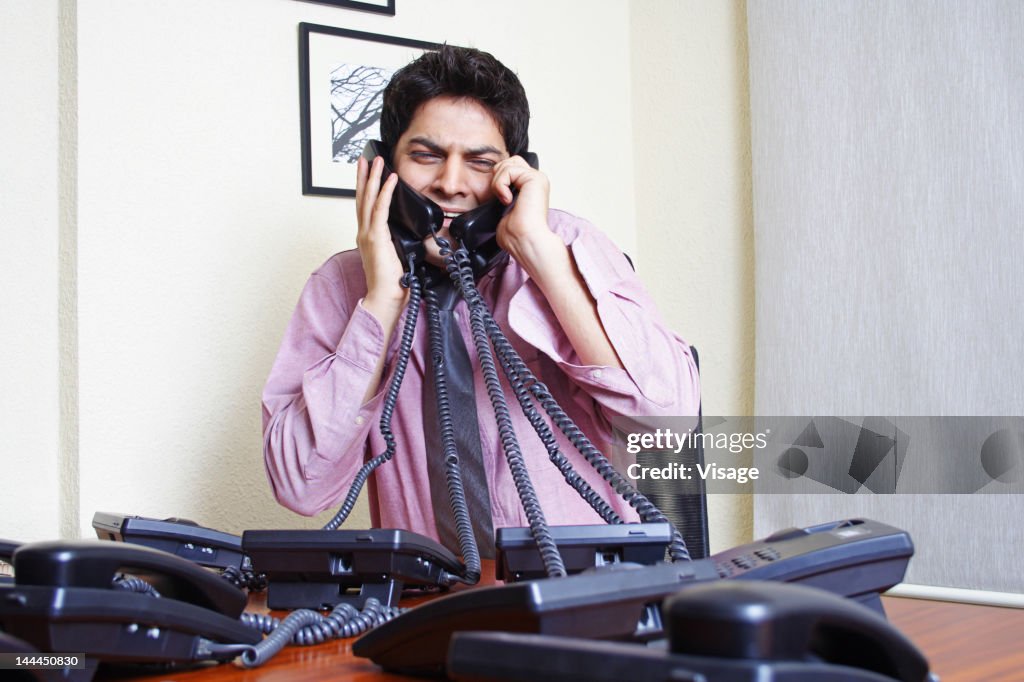 Man Using Many Phones Man Talking On Many Phones High-Res Stock Photo - Getty Images