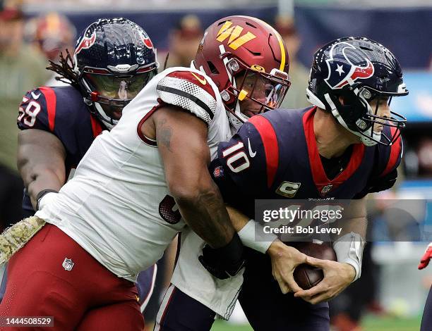 Davis Mills of the Houston Texans is sacked by Daron Payne of the Washington Commanders at NRG Stadium on November 20, 2022 in Houston, Texas.