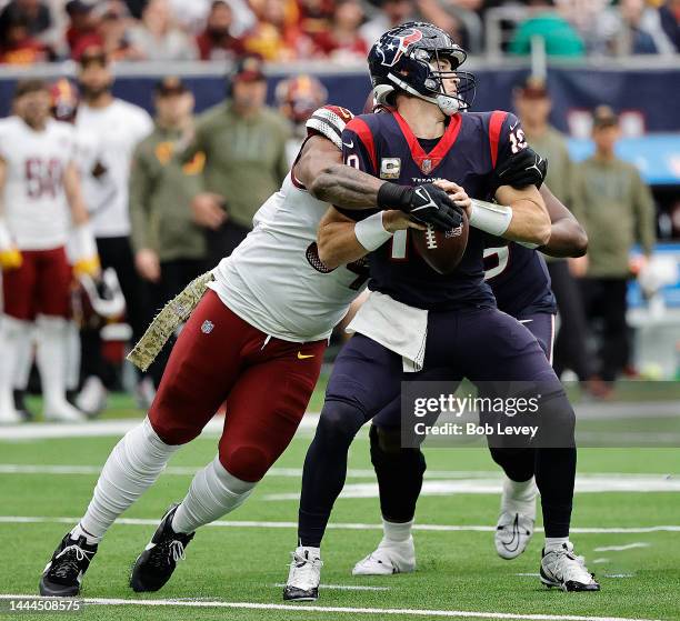 Davis Mills of the Houston Texans is sacked by Daron Payne of the Washington Commanders at NRG Stadium on November 20, 2022 in Houston, Texas.