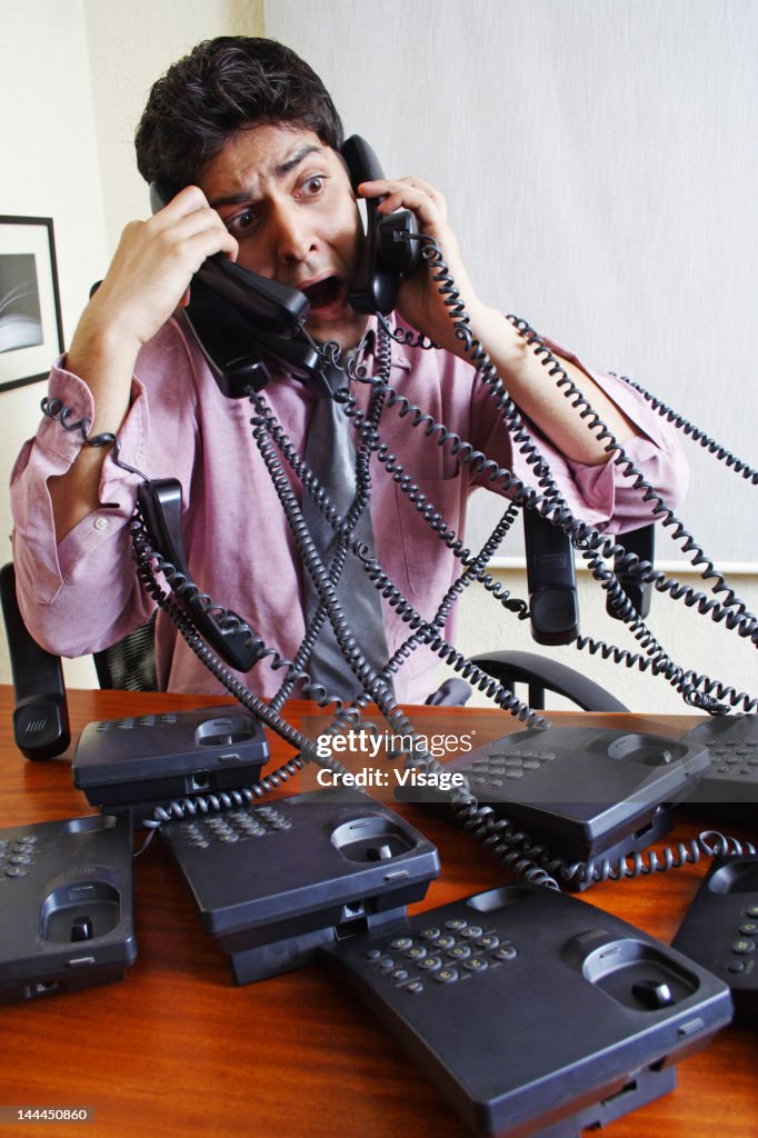 Man Using Many Phones Man Talking On Many Phones High-Res Stock Photo - Getty Images