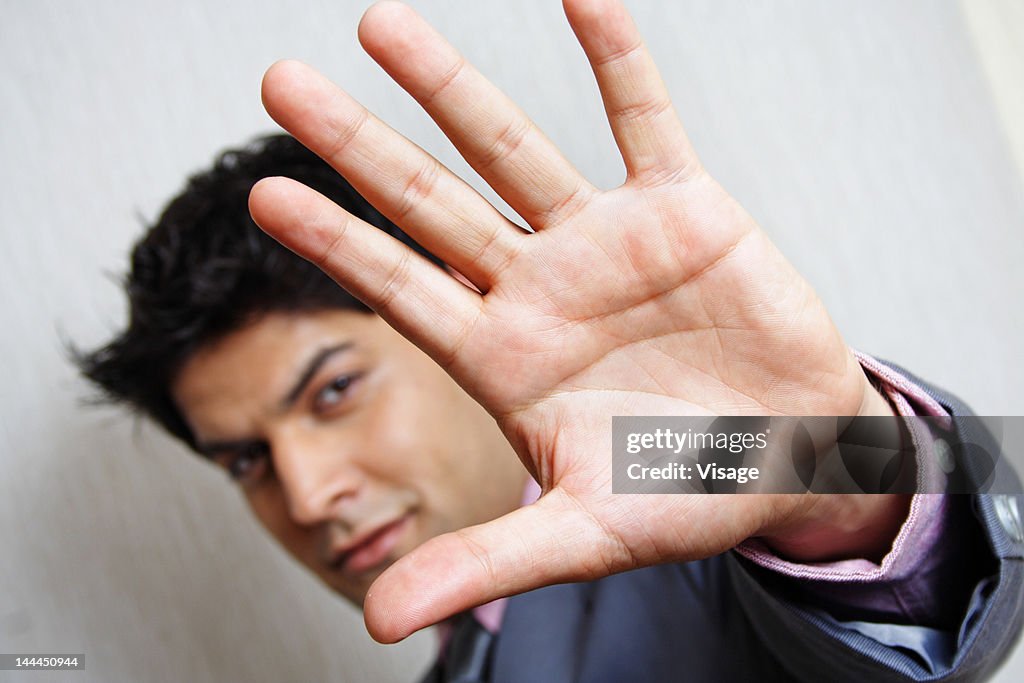 Close up of a business man gesturing stop