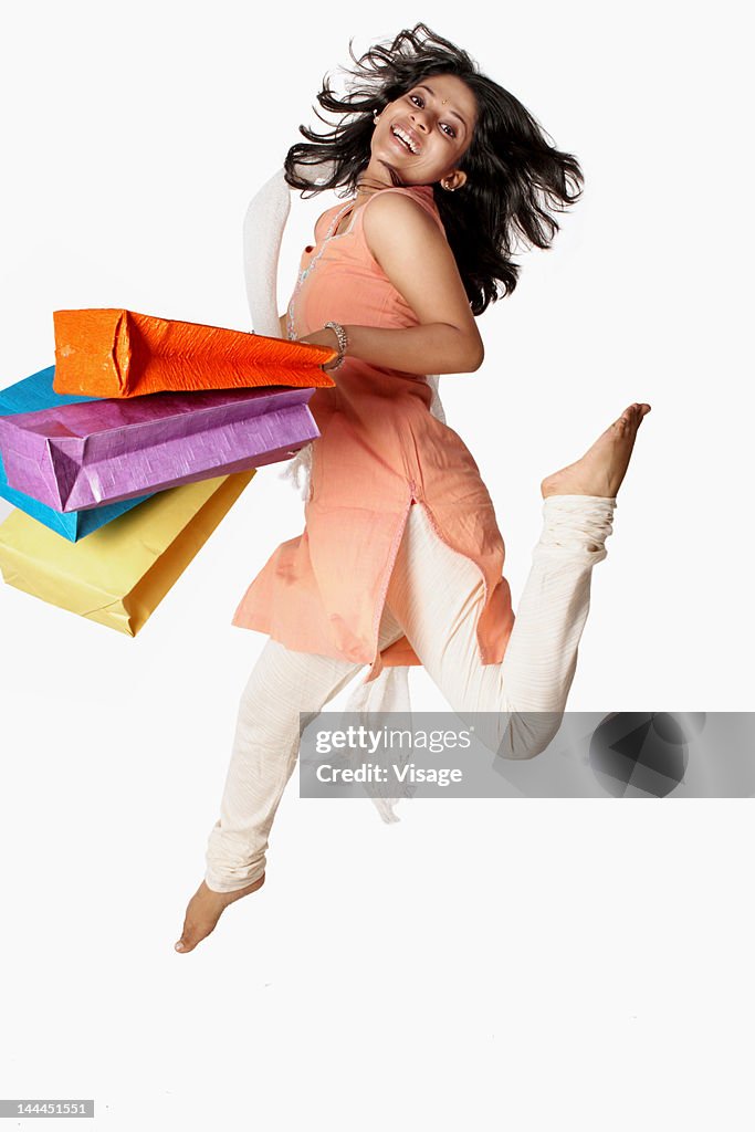 Excited woman holding shopping bags