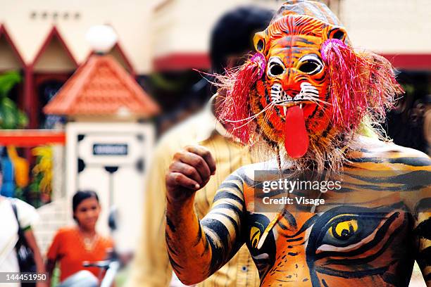 man disguised like a tiger during onam - onam stock pictures, royalty-free photos & images