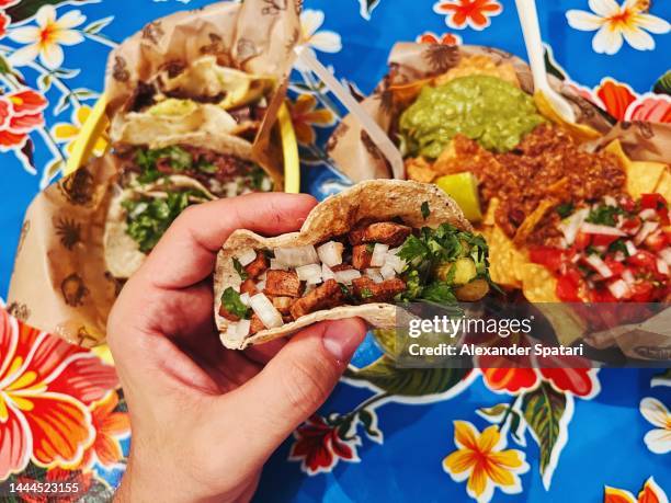 eating tacos at mexican restaurant, personal perspective view - taco 個照片及圖片檔