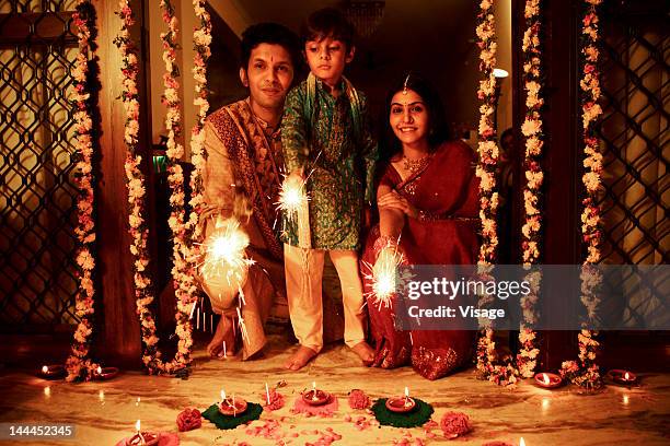 a family celebrating diwali - diwali family stock pictures, royalty-free photos & images