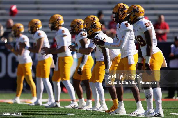 Quarterback Emory Jones of the Arizona State Sun Devils warms up with teammates before the NCAAF game against the Arizona Wildcats at Arizona Stadium...