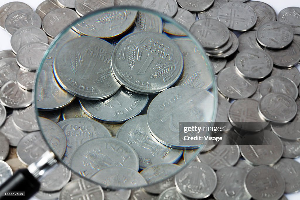 Close up of coins through magnifying glass