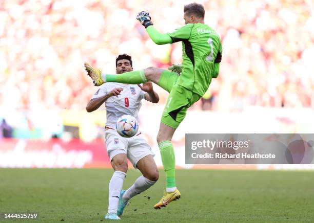 Mehdi Taremi of IR Iran is fouled by Wayne Hennessey of Wales during the FIFA World Cup Qatar 2022 Group B match between Wales and IR Iran at Ahmad...