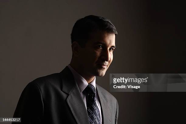 portrait of a businessman - corporate dark portrait stock-fotos und bilder