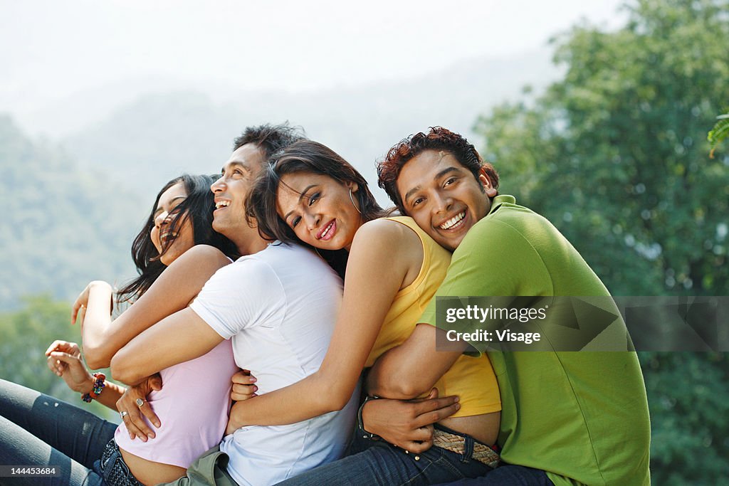 Young men and women embracing each other
