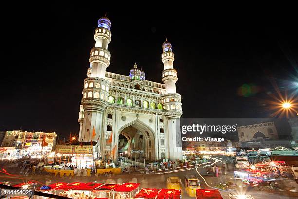 low angle view of charminar at night - hyderabad indien stockfoto's en -beelden