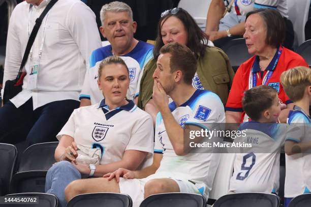 Harry Kane of England looks dejected as he speaks with his wife, Katie Goodland in the stands following the FIFA World Cup Qatar 2022 Group B match...