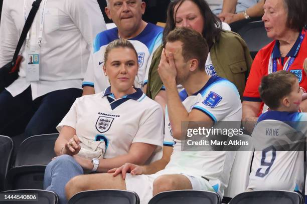 Harry Kane of England looks dejected as he speaks with his wife, Katie Goodland in the stands following the FIFA World Cup Qatar 2022 Group B match...