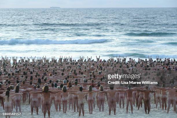 Members of the public pose at sunrise for photographic artist Spencer Tunick at Bondi Beach on November 26, 2022 in Sydney, Australia. US artist and...