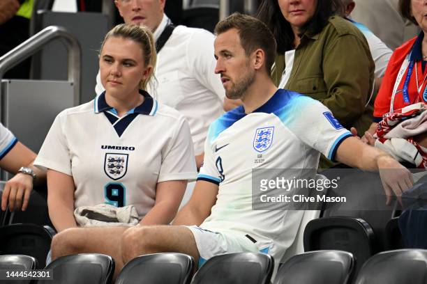 Harry Kane of England interacts with their partner Katie Goodland after the 0-0 draw during the FIFA World Cup Qatar 2022 Group B match between...