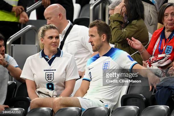 Harry Kane of England interacts with their partner Katie Goodland after the 0-0 draw during the FIFA World Cup Qatar 2022 Group B match between...