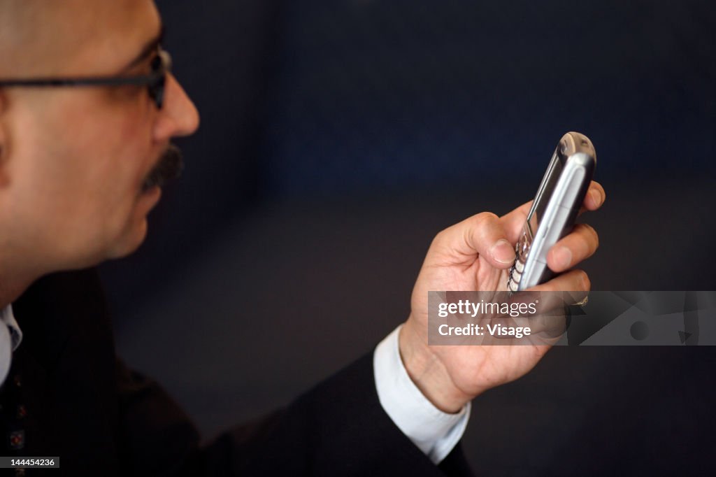 Partial view of a man using a mobile phone