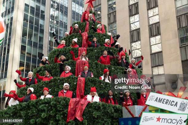 Carolers sing on the Macy's Singing Christmas Tree during the 2022 Macy's Thanksgiving Day Parade on November 24, 2022 in New York City.
