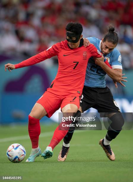 Son Heung-Min of Korea Republic and Martin Caceres of Uraguay in action during the FIFA World Cup Qatar 2022 Group H match between Uruguay and Korea...