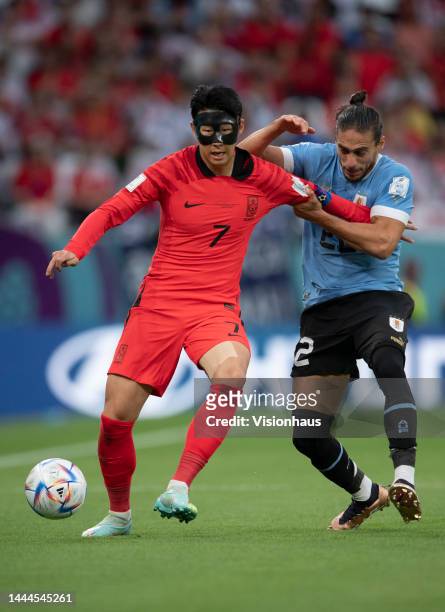 Son Heung-Min of Korea Republic and Martin Caceres of Uraguay in action during the FIFA World Cup Qatar 2022 Group H match between Uruguay and Korea...