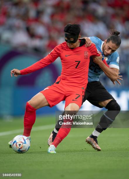 Son Heung-Min of Korea Republic and Martin Caceres of Uraguay in action during the FIFA World Cup Qatar 2022 Group H match between Uruguay and Korea...