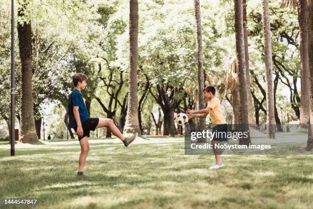 kids, brothers playing soccer in the park - movinglove 15, 2019 stock pictures, royalty-free photos & images