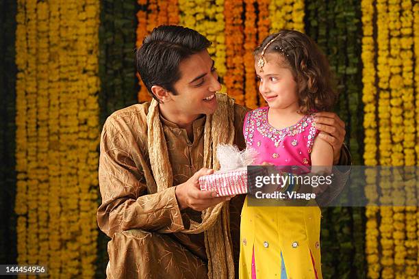 portrait of a father and daughter holding a gift box - bangle stock pictures, royalty-free photos & images