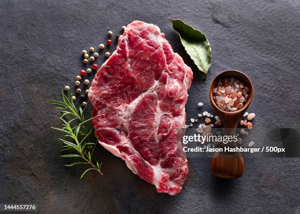 high angle view of meat with spices on table,united states,usa - cut of meat stock pictures, royalty-free photos & images