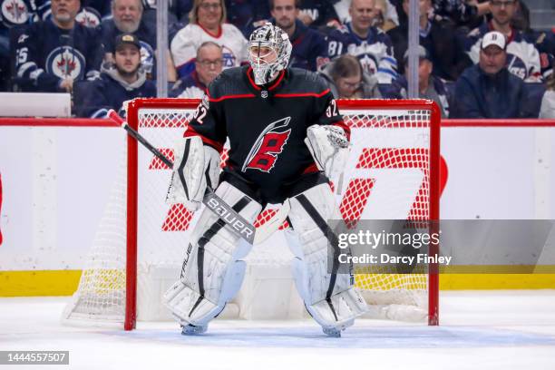 Goaltender Pyotr Kochetkov of the Carolina Hurricanes guards the net during second period action against the Winnipeg Jets at the Canada Life Centre...