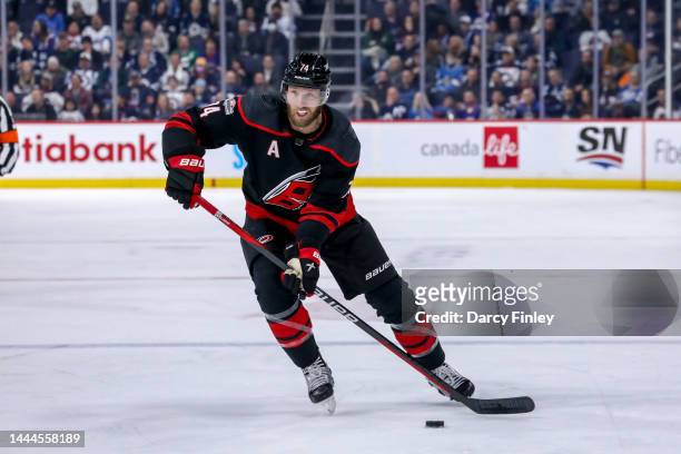 Jaccob Slavin of the Carolina Hurricanes plays the puck down the ice during third period action against the Winnipeg Jets at the Canada Life Centre...