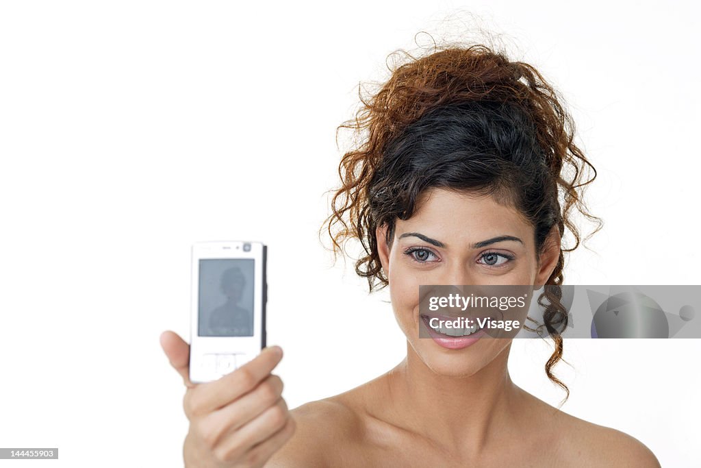 Young woman clicking her own picture, mobile phone