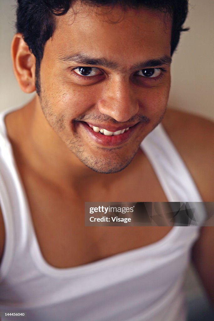 A young man looking up and smiling