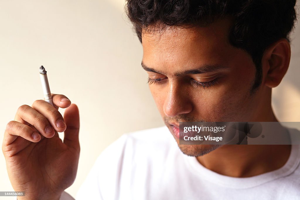 Young man holding a cigarette