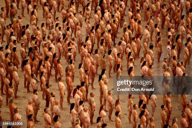 Members of the public pose at Bondi Beach on November 26, 2022 in Sydney, Australia. US artist and photographer Spencer Tunick created the nude...